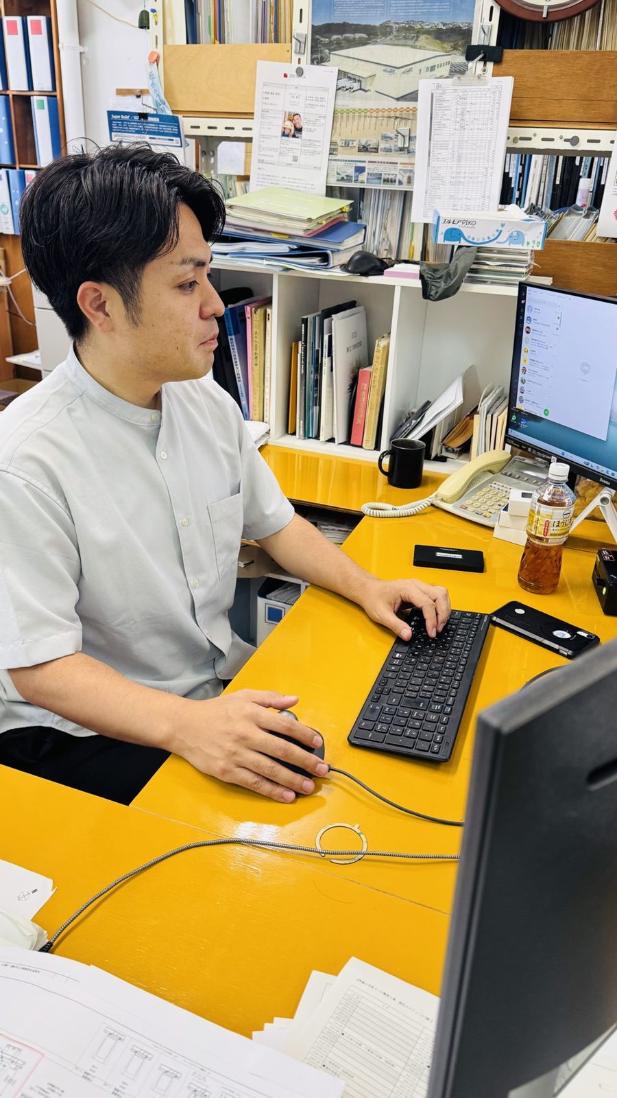 デスクで図面作成に集中する様子